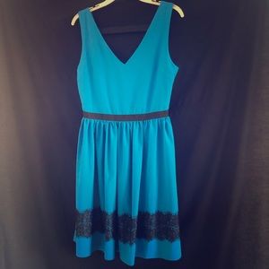 Blue knee-length dress with elastic back.